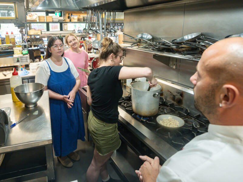 A man teaching an Italian cooking class